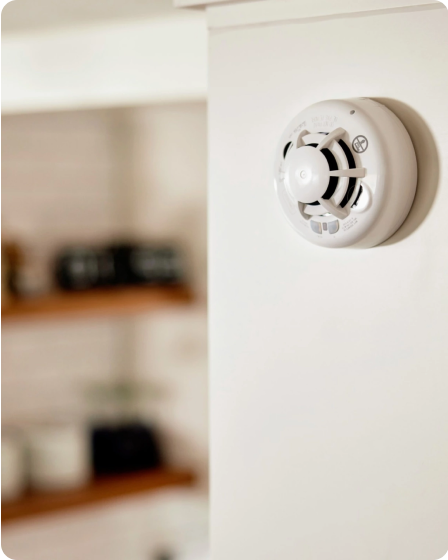 Smoke and CO Detector installed on wall with blurry background
